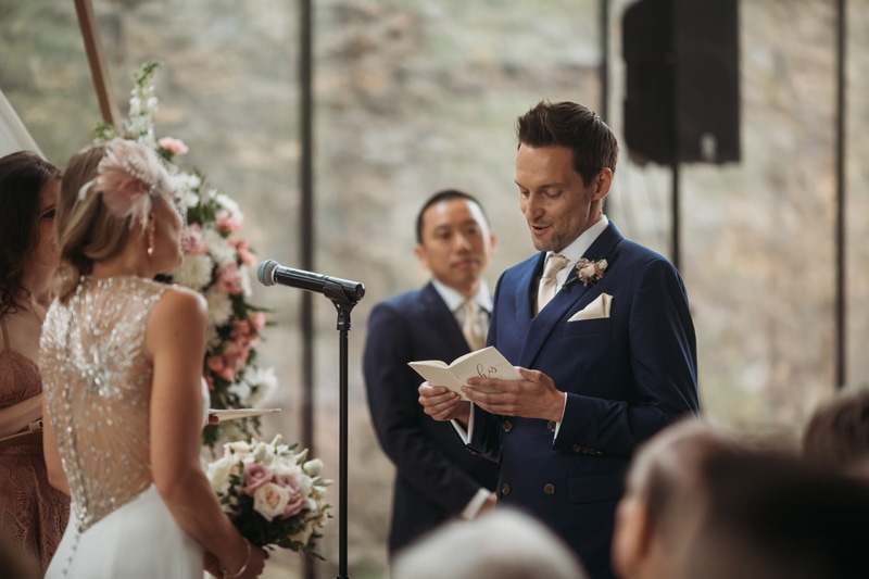 Wedding Photographer, the groom reads his vows to his wife-to-be