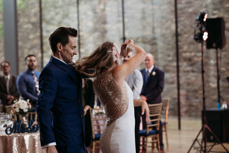 Wedding Photographer, the groom spins the bride during a dance at their reception