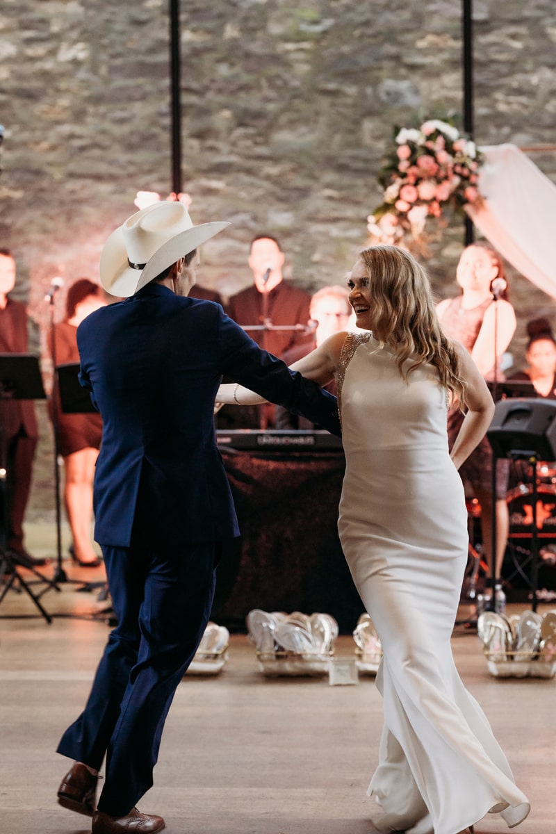 Wedding Photographer, the bride and the groom dance, the groom wears a cowboy hat