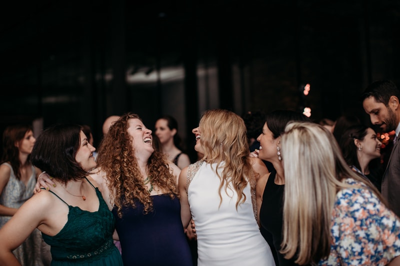 Wedding Photographer, the bride dances and embraces her friends and family