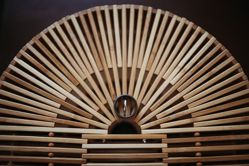 Wedding Photographer, a wedding ring sits on a patterned bamboo decor