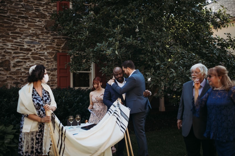 Wedding Photographer, a man hugs a close friend at his wedding