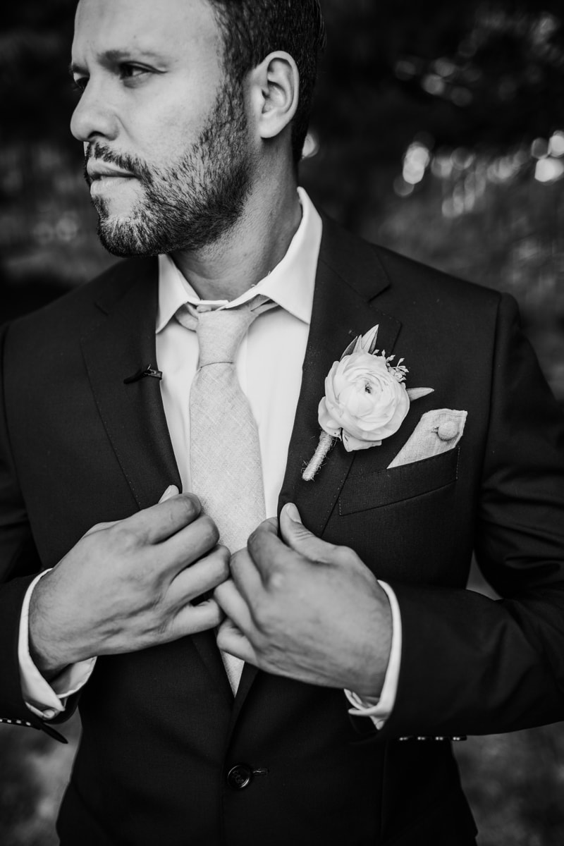 Wedding Photographer, a groom adjusts his suit