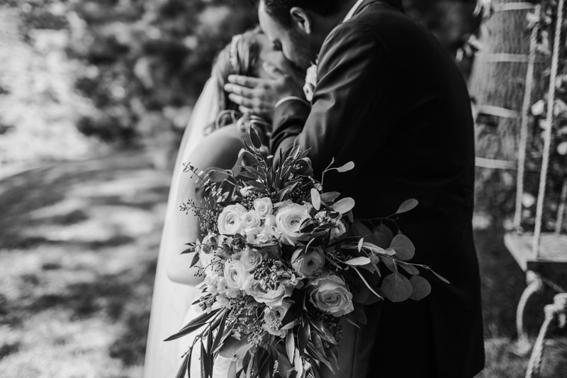 Wedding Photographer, a bride and groom kiss in the garden