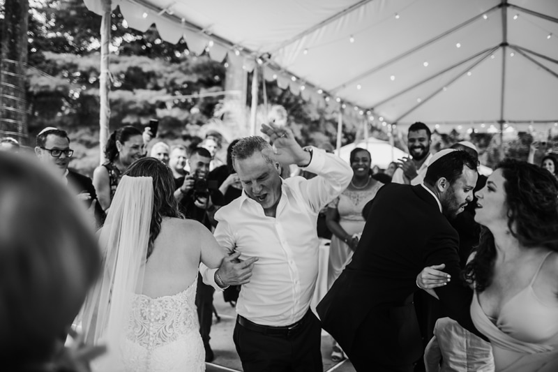 Wedding Photographer, dad dances with his daughter among wedding guests