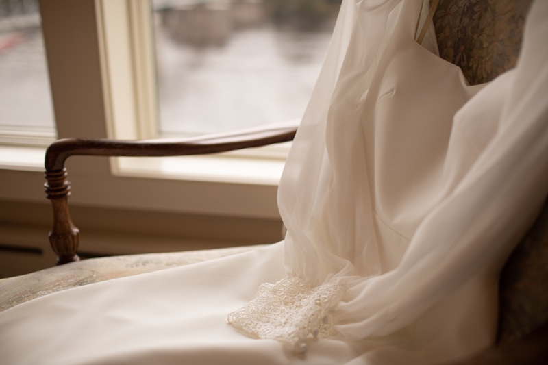 Wedding Photographer, a wedding dress is laid out on a chair
