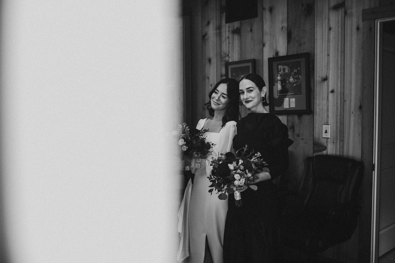 Wedding Photographer, a bride stands smiling with her bridesmaid