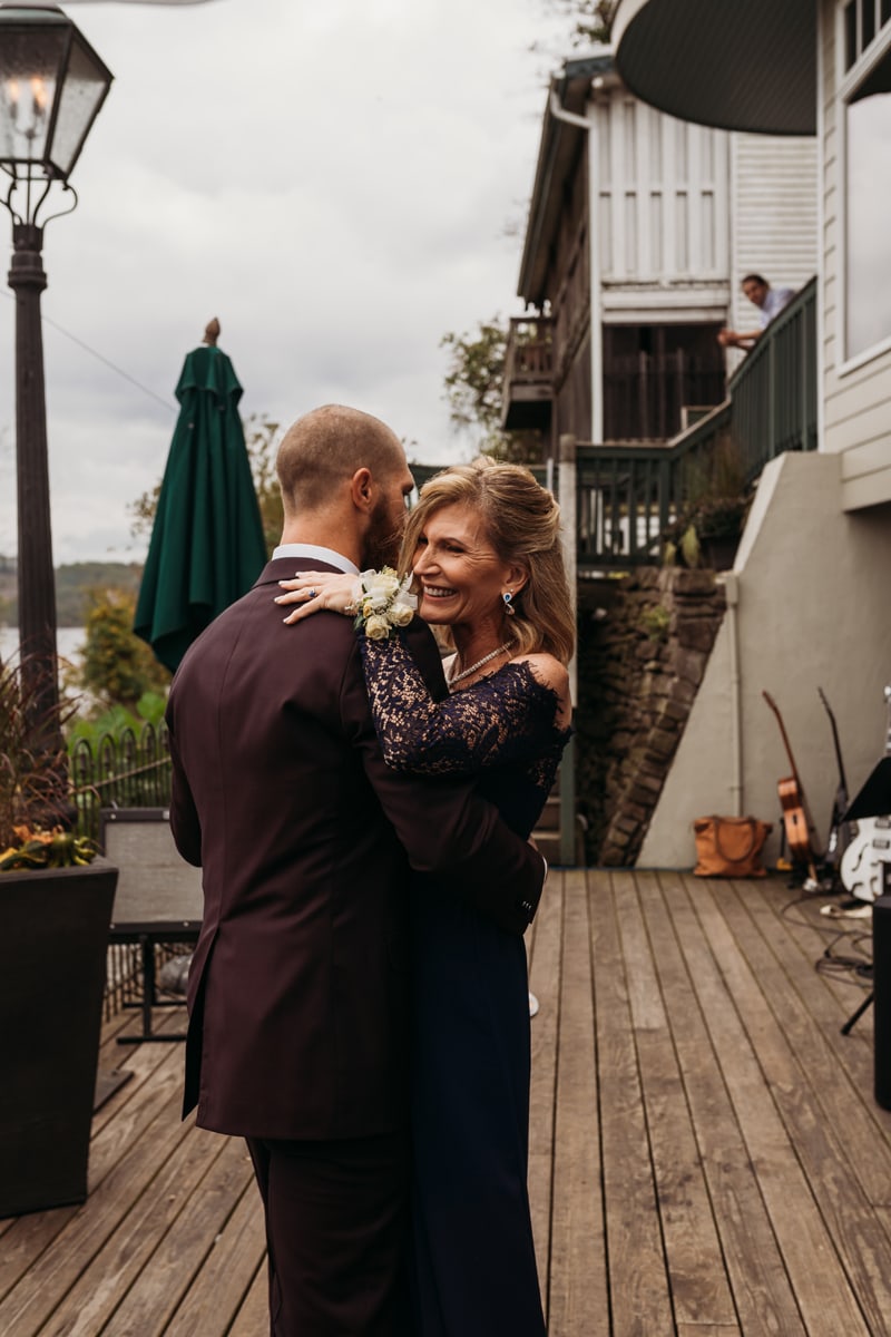 Wedding Photographer, the groom dances with his mother, she smiles
