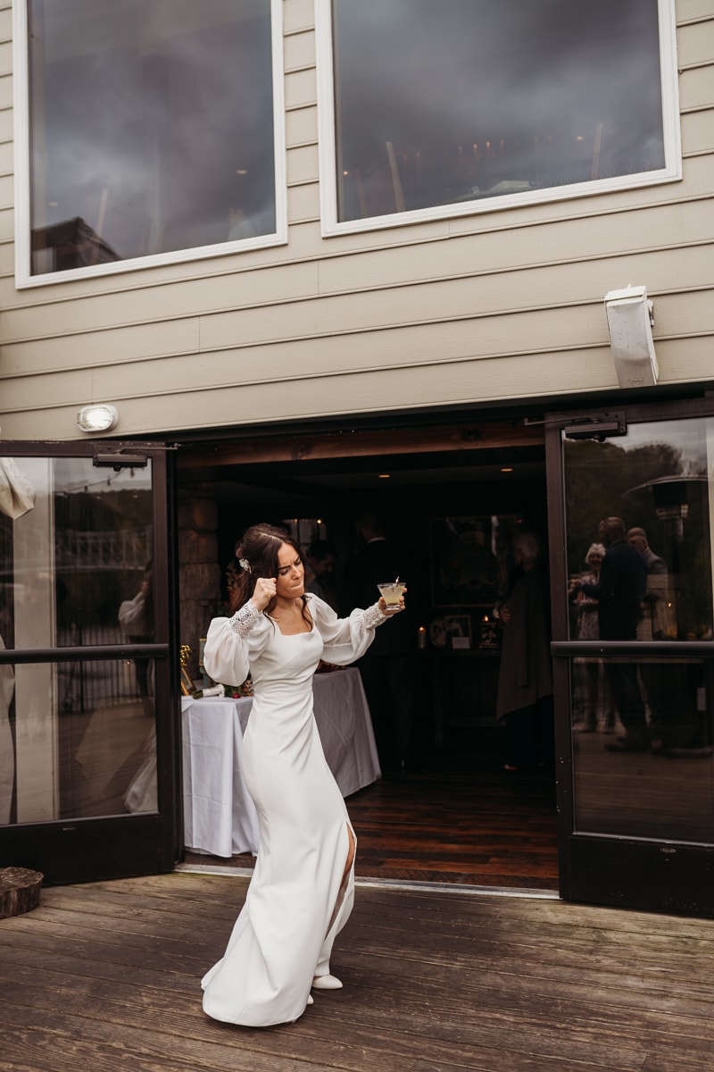 Wedding Photographer, the bride dances with a cocktail in her hand